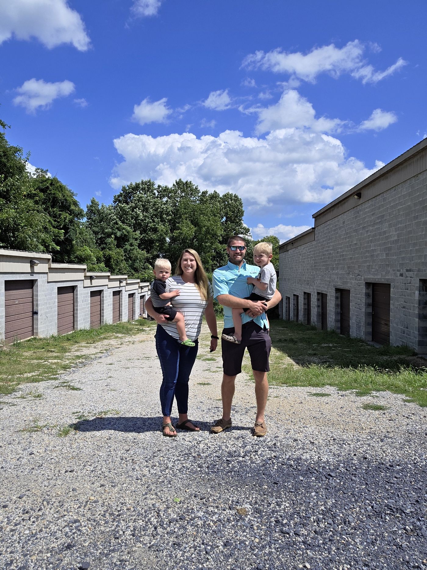Richard and Heather Acri with their two sons standing in the drive aisle between the unit rows at Safe Haven Storage in York Haven, Pennsylvania